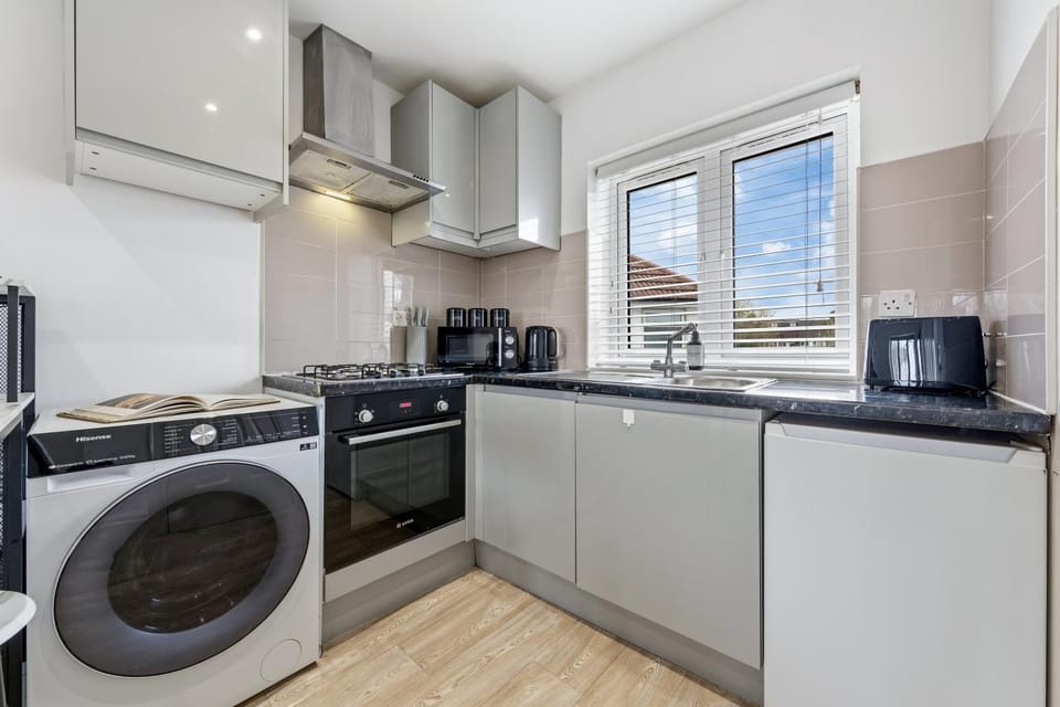 Kitchen or kitchenette, dishwasher, oven, stove, toaster, washing machine