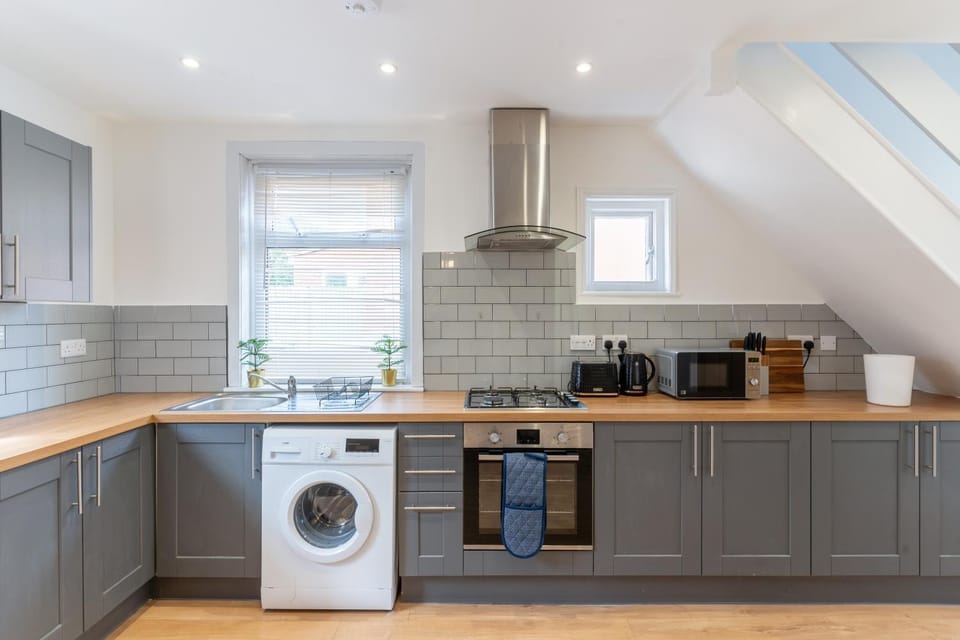 Kitchen or kitchenette, microwave, oven, stove, toaster, washing machine