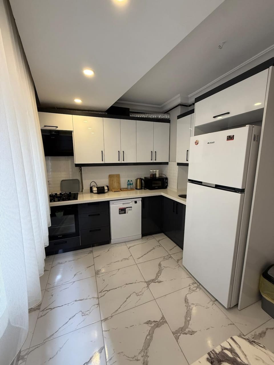 Kitchen or kitchenette, dishwasher, oven, stove