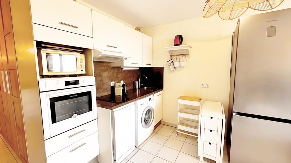 Kitchen or kitchenette, dishwasher, oven, stove, washing machine