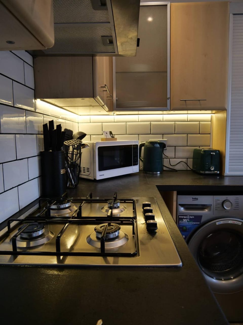 Kitchen or kitchenette, stove, toaster, washing machine
