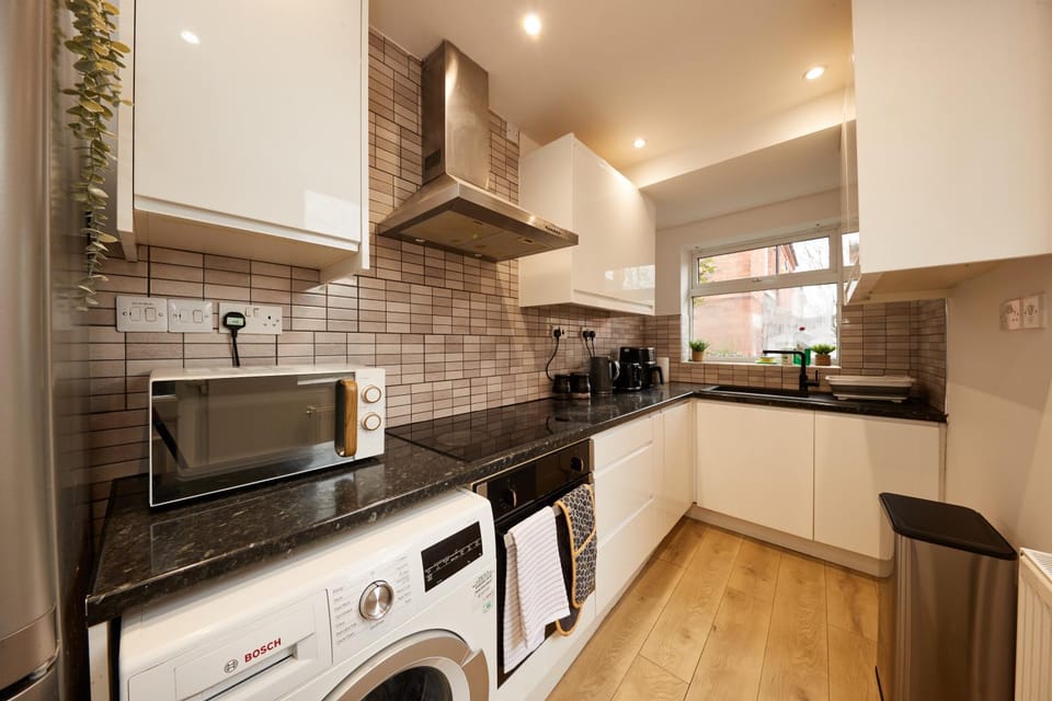 Kitchen or kitchenette, oven, stove, toaster, washing machine