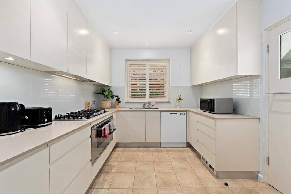 Kitchen or kitchenette, dishwasher, microwave, oven, stove