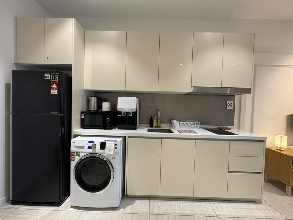Kitchen or kitchenette, microwave, stove, washing machine