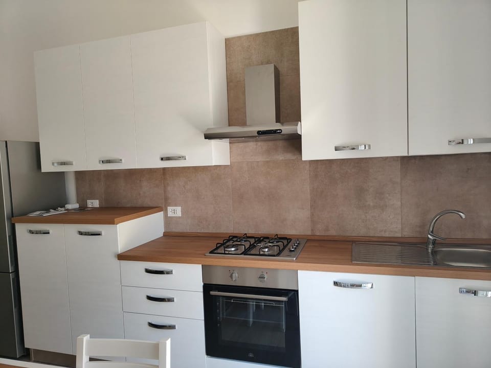 Kitchen or kitchenette, dishwasher, oven, stove
