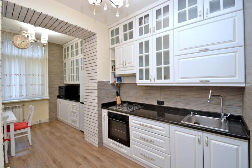 Kitchen or kitchenette, dishwasher, oven, stove