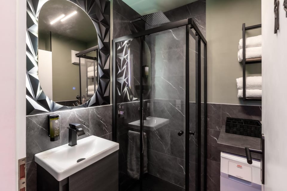 Shower, Bathroom, hair dryier, towels, washing machine