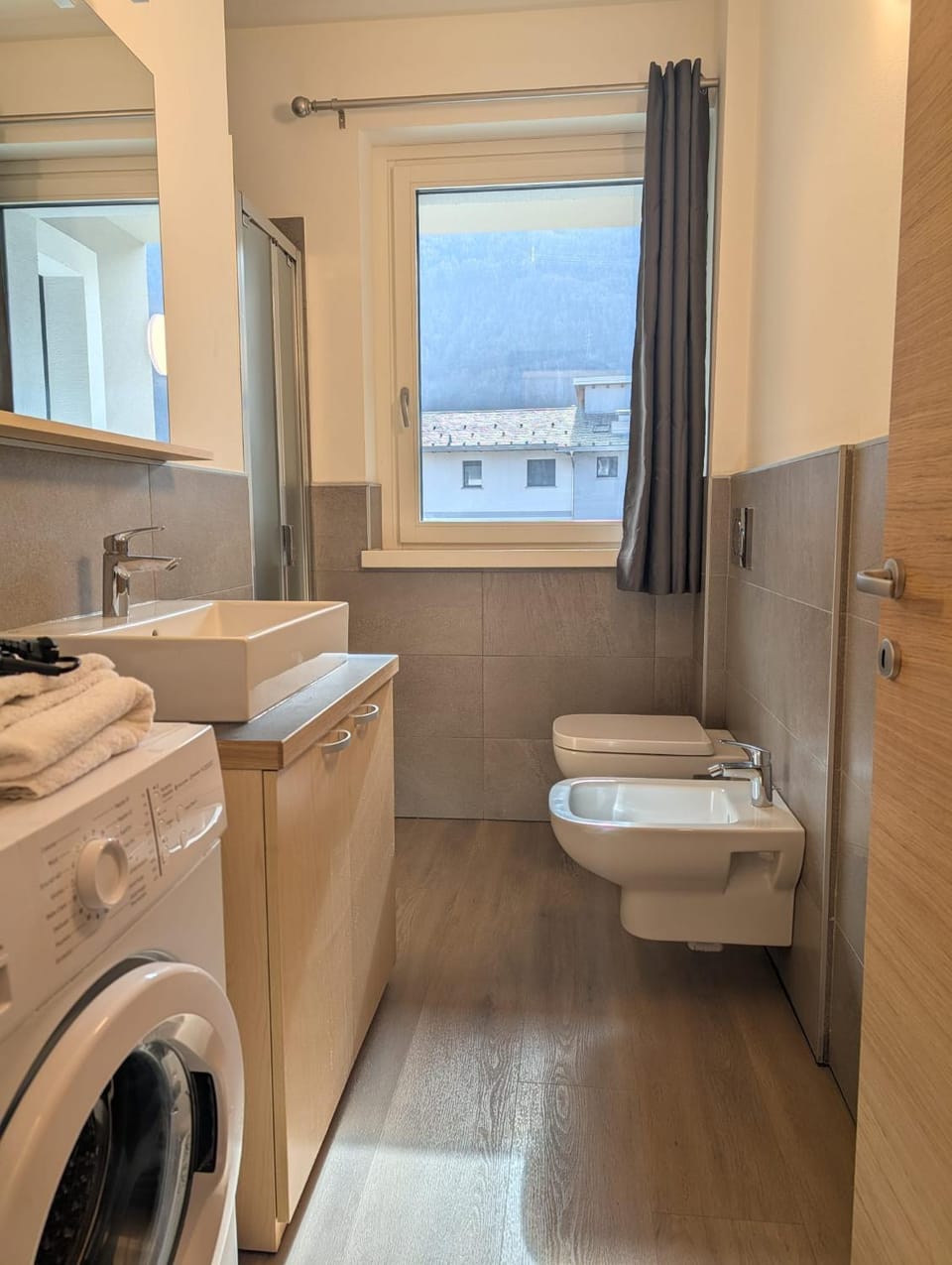 Bathroom, hair dryier, towels, washing machine