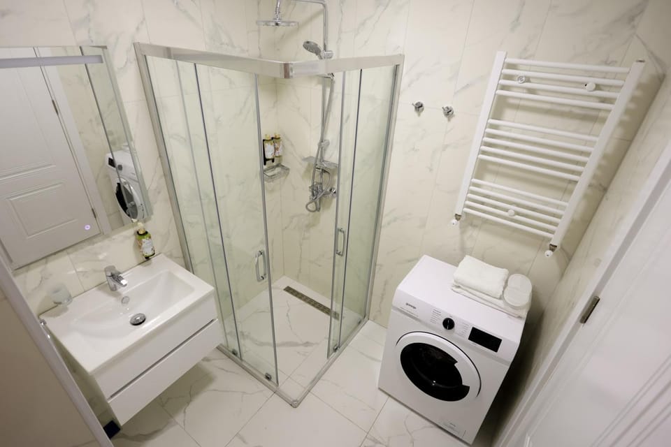 Shower, Toilet, Bathroom, towels, washing machine, dryer