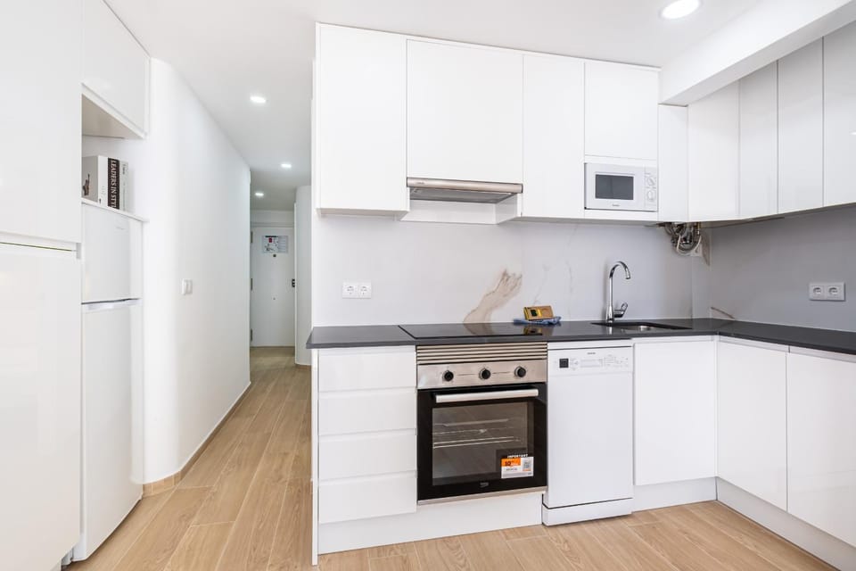 Kitchen or kitchenette, dishwasher, microwave, oven, stove