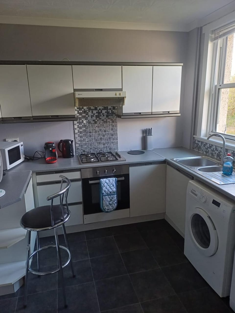 Kitchen or kitchenette, oven, stove, toaster, washing machine