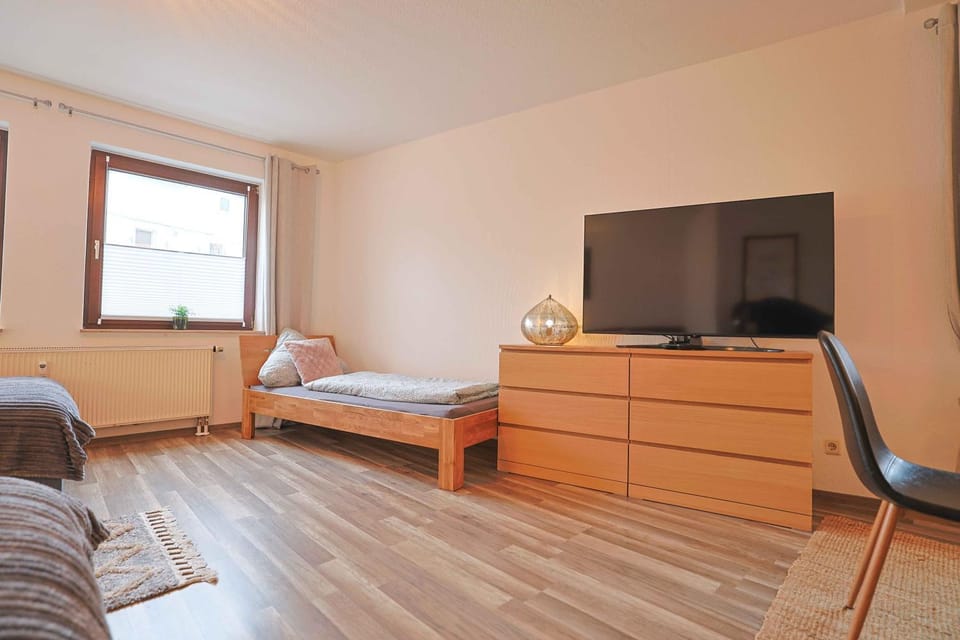 Bed, TV and multimedia, Living room, Seating area, Bedroom