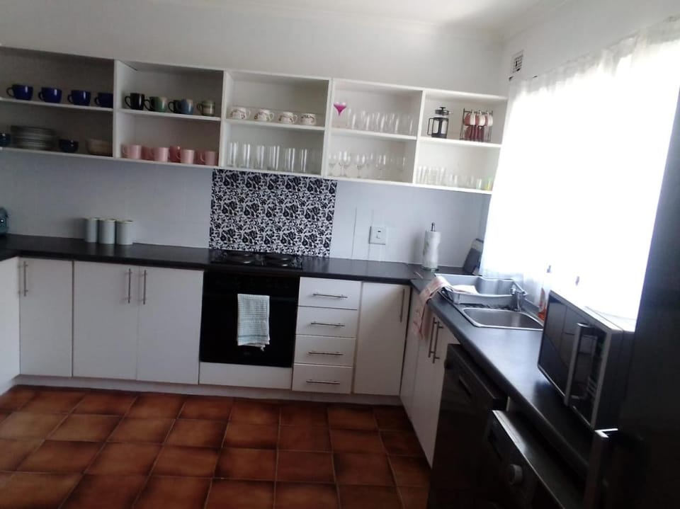 Kitchen or kitchenette, dishwasher, oven, stove