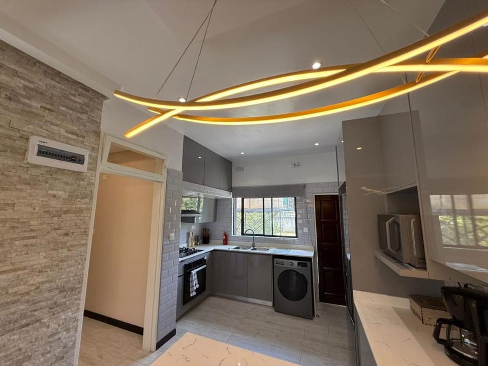 Kitchen or kitchenette, oven, stove, toaster, washing machine, dryer, air conditioner