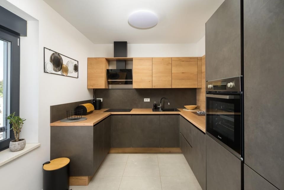 Kitchen or kitchenette, dishwasher, oven, stove