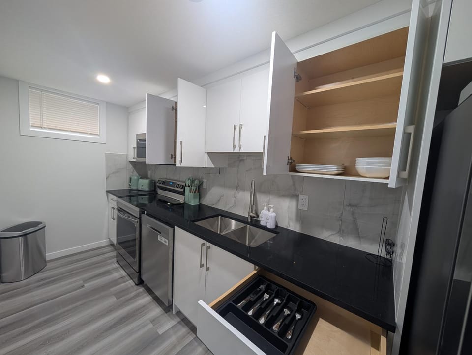 Kitchen or kitchenette, dishwasher, oven, stove