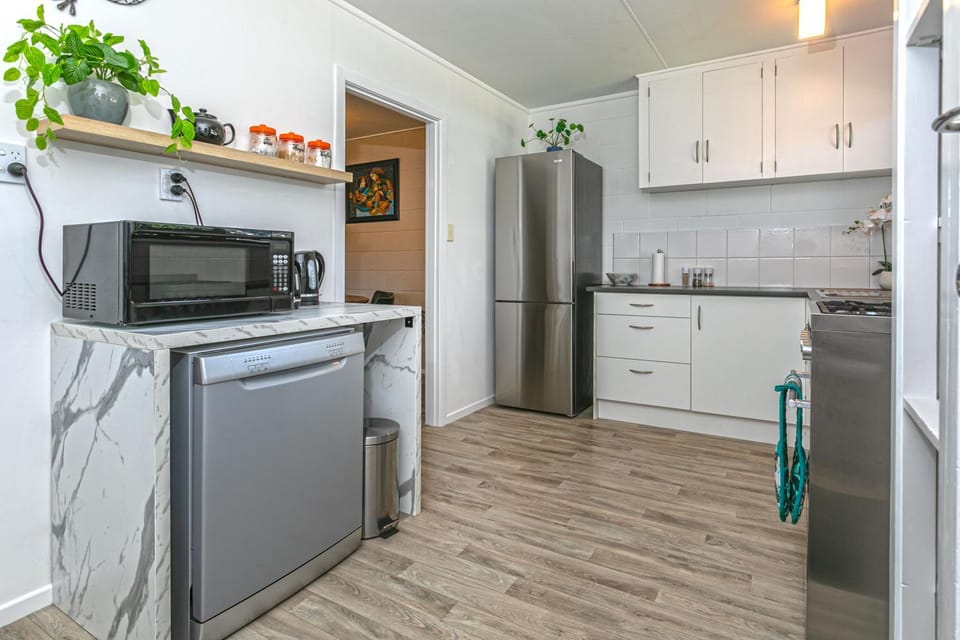 Kitchen or kitchenette, dishwasher, oven, stove