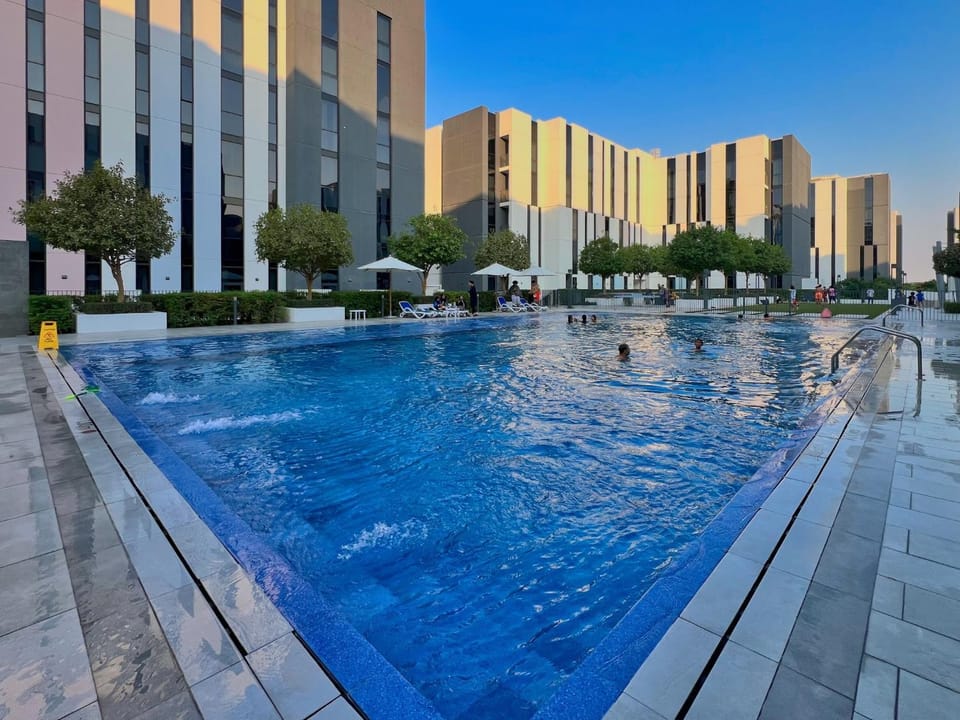 Marble Studio Aljada l Pool & Gym l Cozy Community Apartment in Al Sharjah