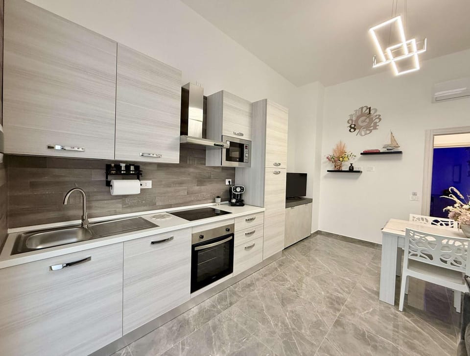 Kitchen or kitchenette, dishwasher, oven, stove