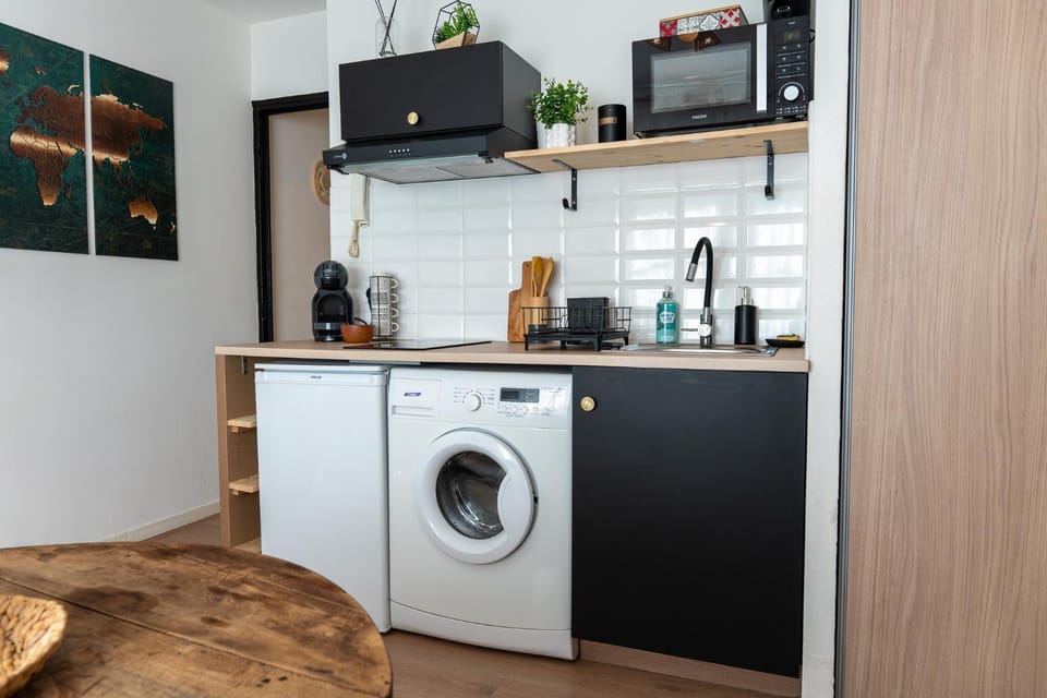 Kitchen or kitchenette, flat iron, microwave, stove, washing machine