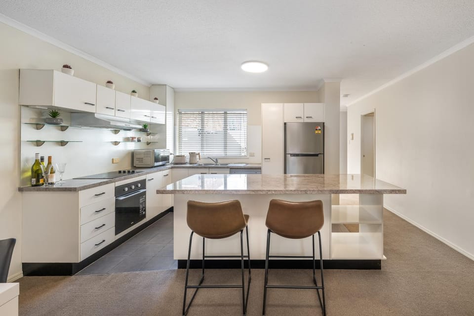 Kitchen or kitchenette, dishwasher, oven, stove
