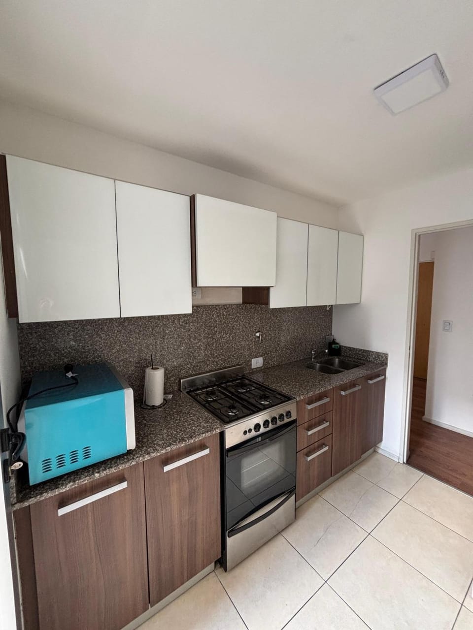 Kitchen or kitchenette, microwave, stove, toaster