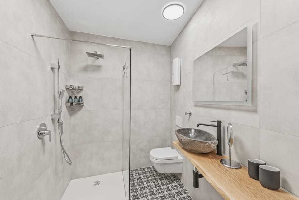 Shower, Toilet, Bathroom, hair dryier, towels, washing machine, dryer
