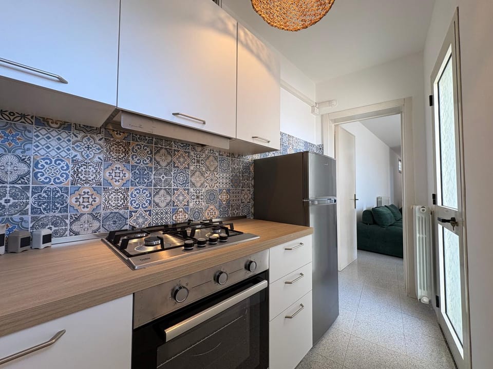 Kitchen or kitchenette, dishwasher, oven, stove