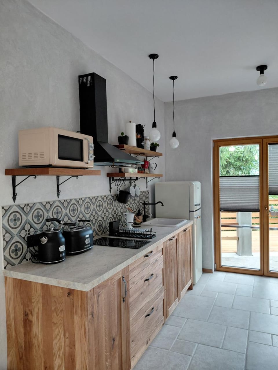 Kitchen or kitchenette, dishwasher, furniture, microwave, stove, toaster