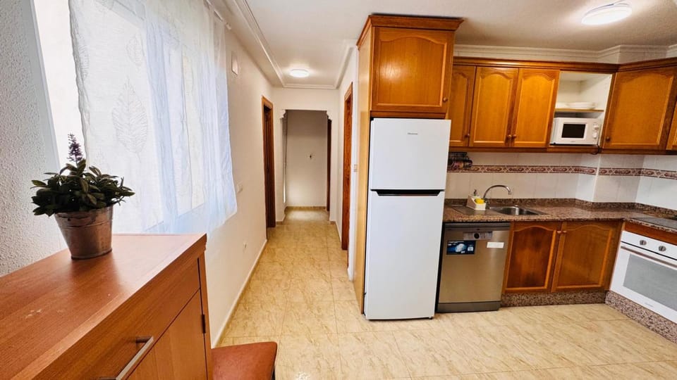 Kitchen or kitchenette, dishwasher, oven, stove