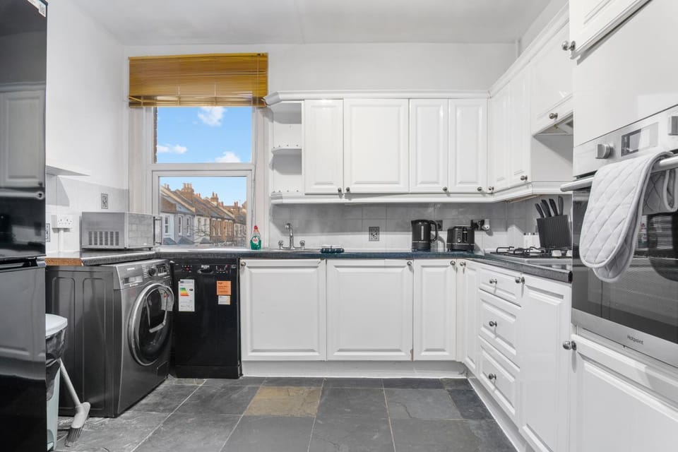 Kitchen or kitchenette, dishwasher, oven, stove, toaster, washing machine, dryer