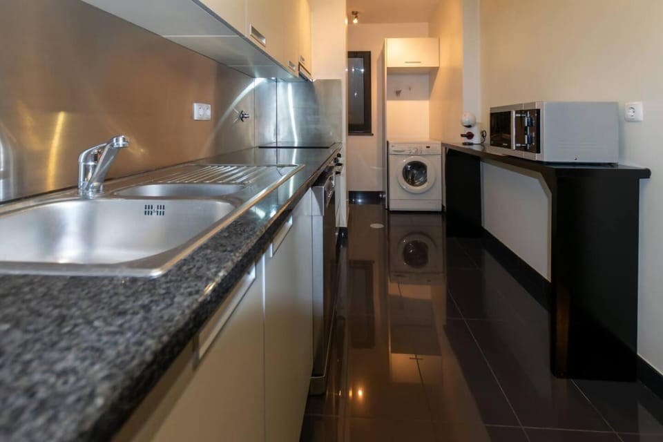 Kitchen or kitchenette, dishwasher, oven, stove, washing machine
