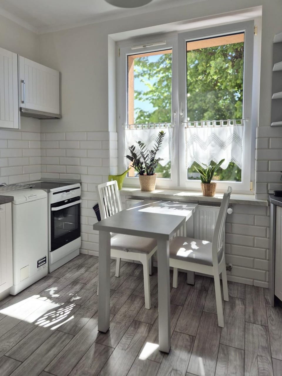 Kitchen or kitchenette, dishwasher, microwave, stove, toaster, washing machine
