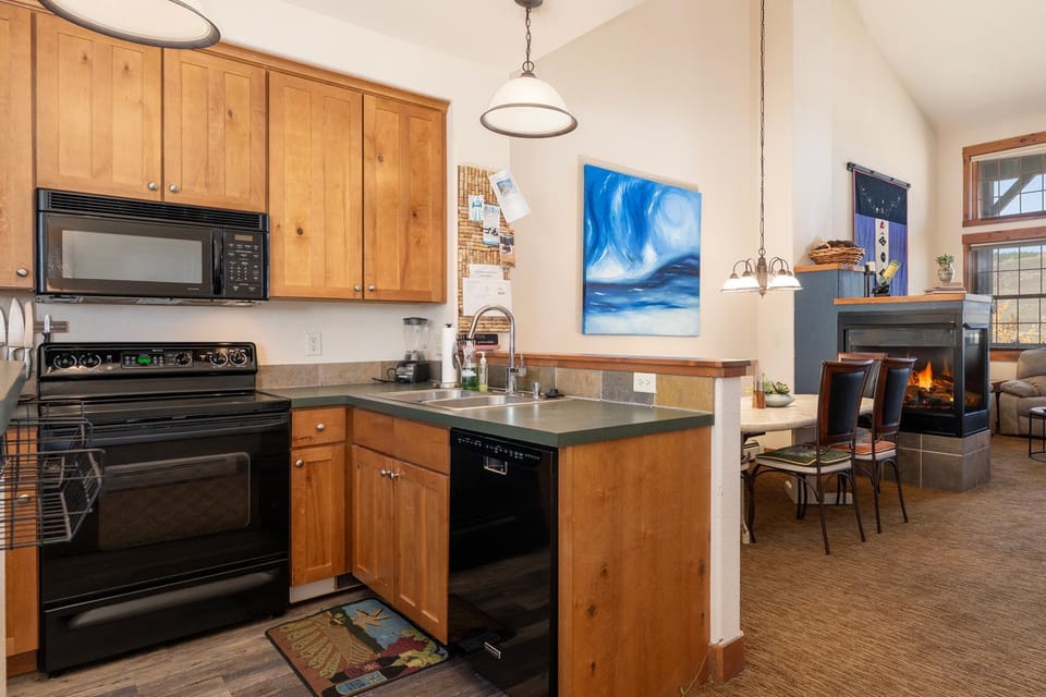 Kitchen or kitchenette, Living room, Seating area, Dining area, fireplace, furniture, microwave, oven, stove, kitchen