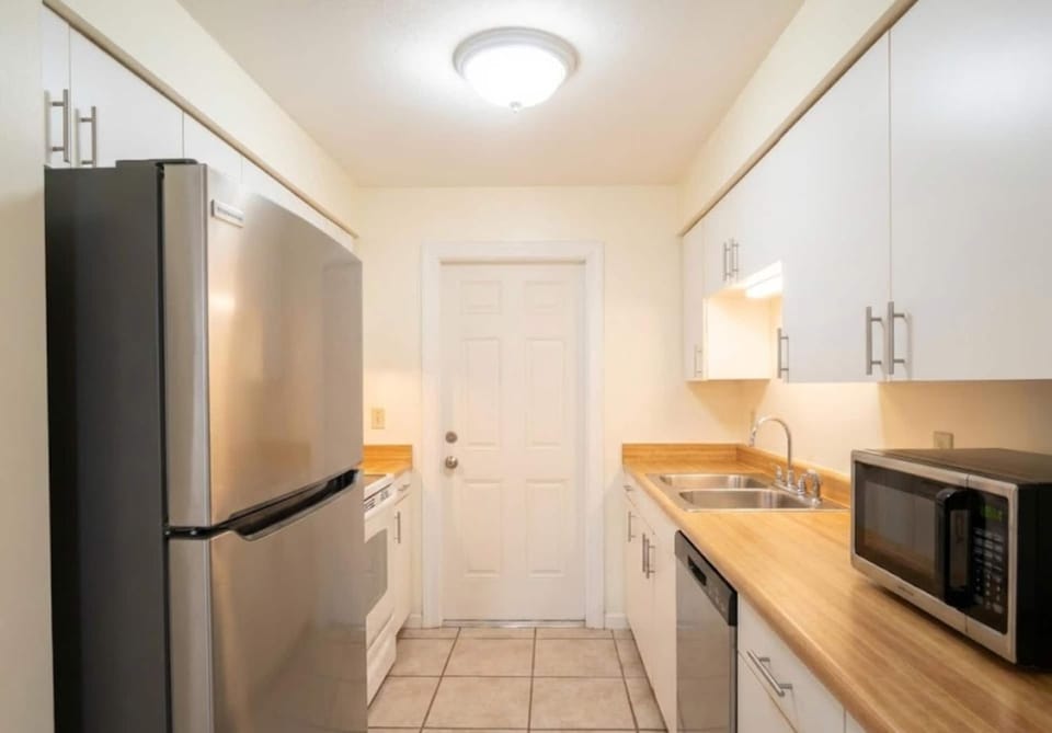 Kitchen or kitchenette, dishwasher, microwave, oven, stove