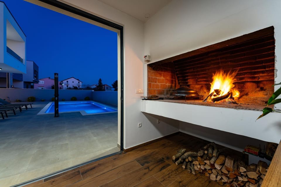 Property building, Patio, Night, Natural landscape, View (from property/room), Pool view, Swimming pool, fireplace, sunbed