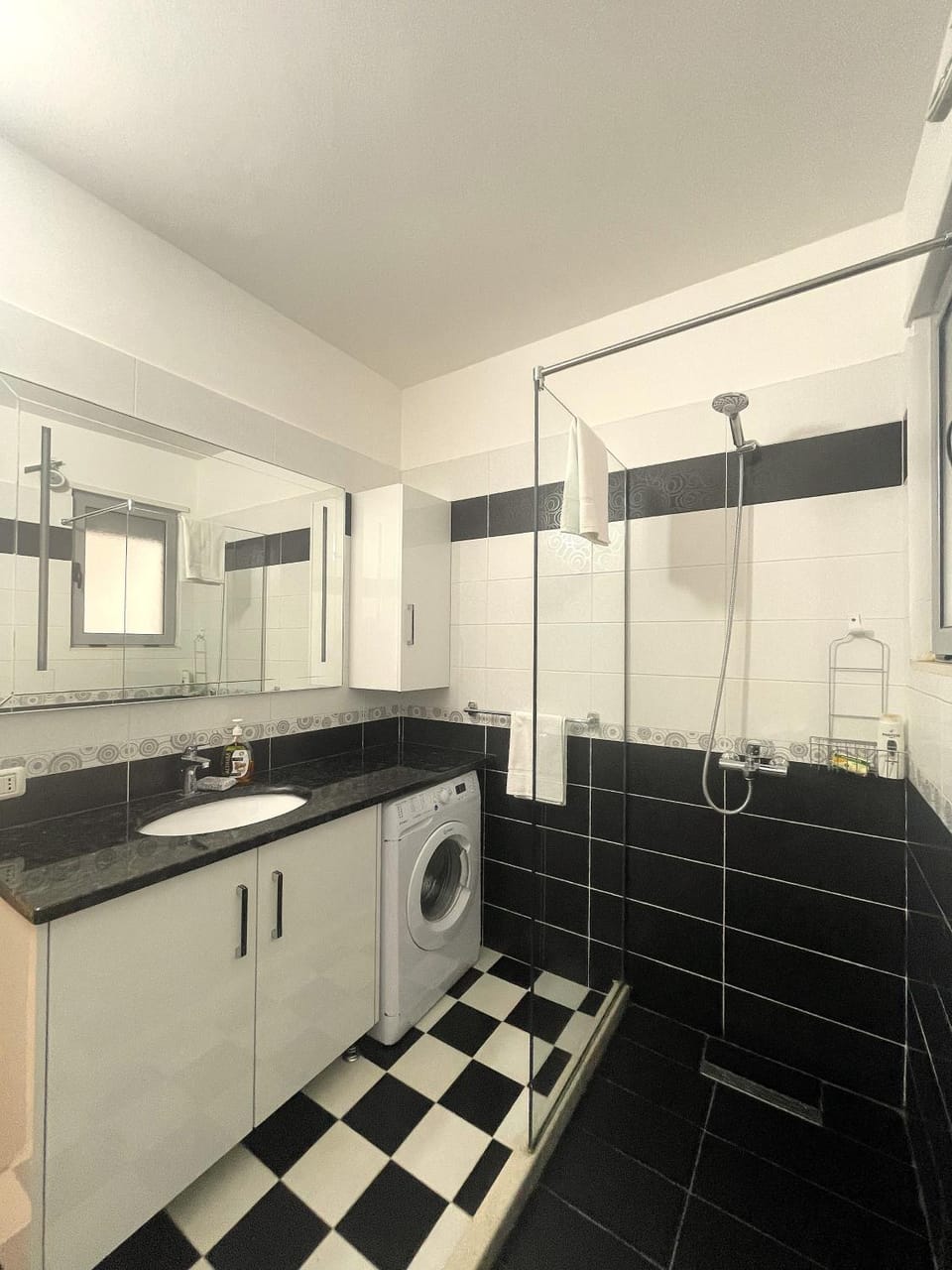 Shower, Bathroom, hair dryier, towels, washing machine