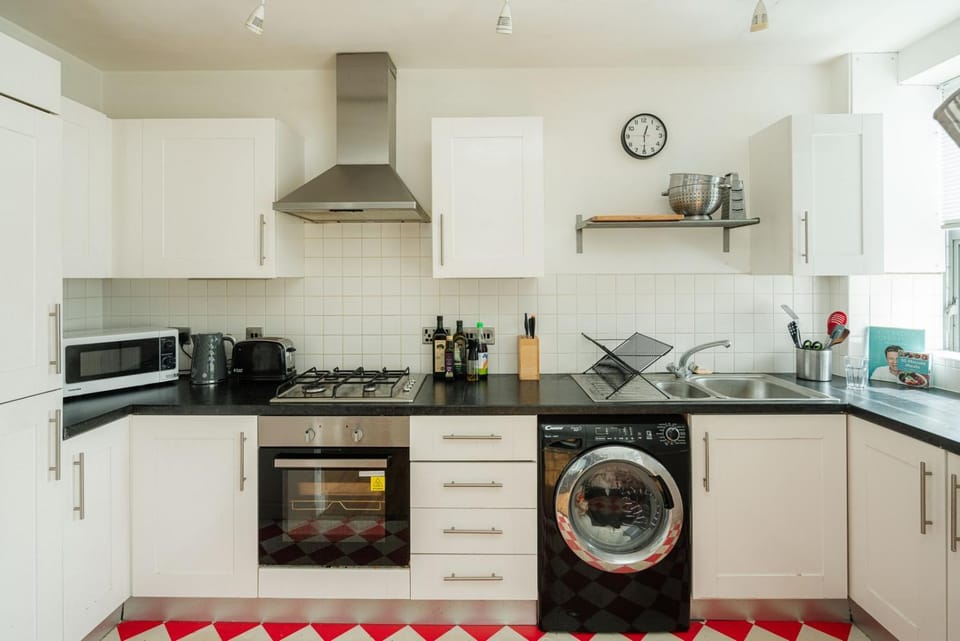 Kitchen or kitchenette, microwave, oven, stove, toaster, washing machine