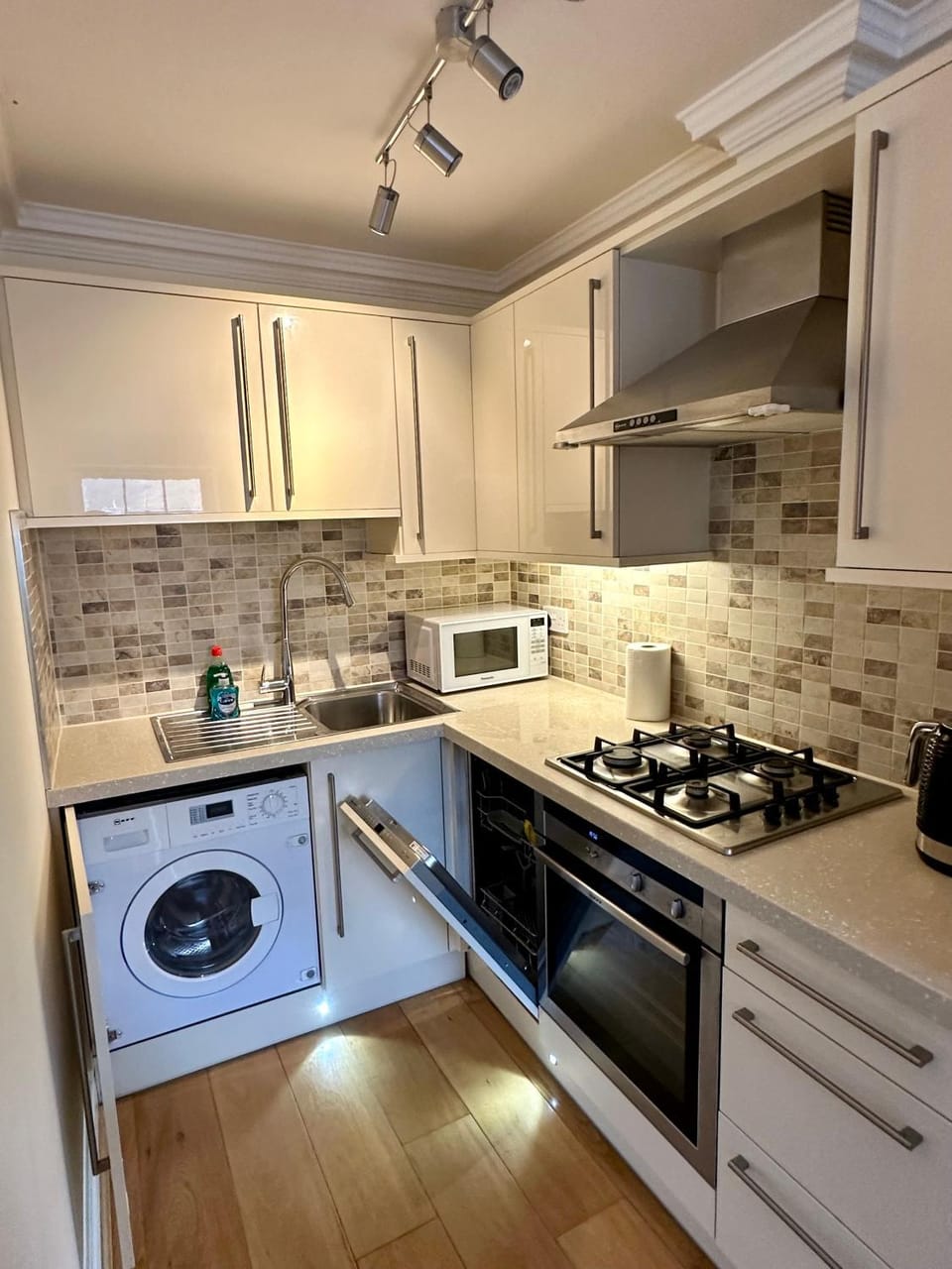 Kitchen or kitchenette, dishwasher, oven, stove, toaster, washing machine