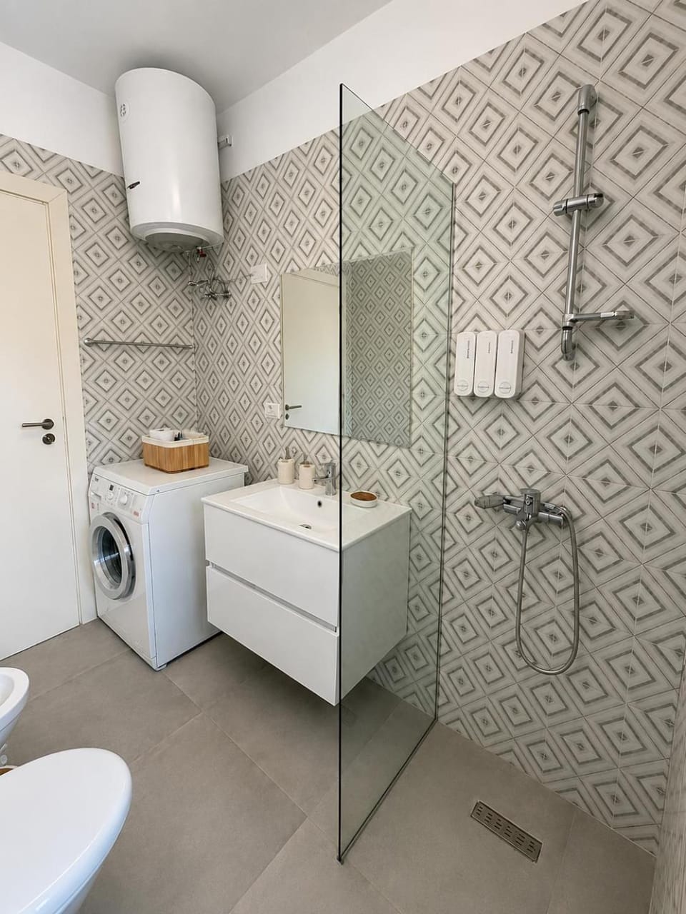 Shower, Toilet, Bathroom, bidet, hair dryier, towels, washing machine, dryer