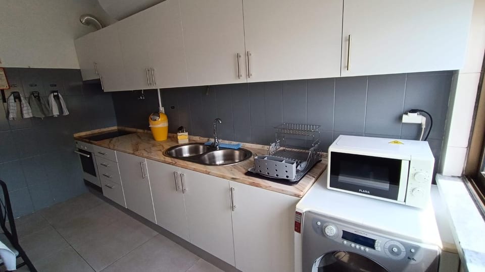 Kitchen or kitchenette, oven, stove, toaster, washing machine