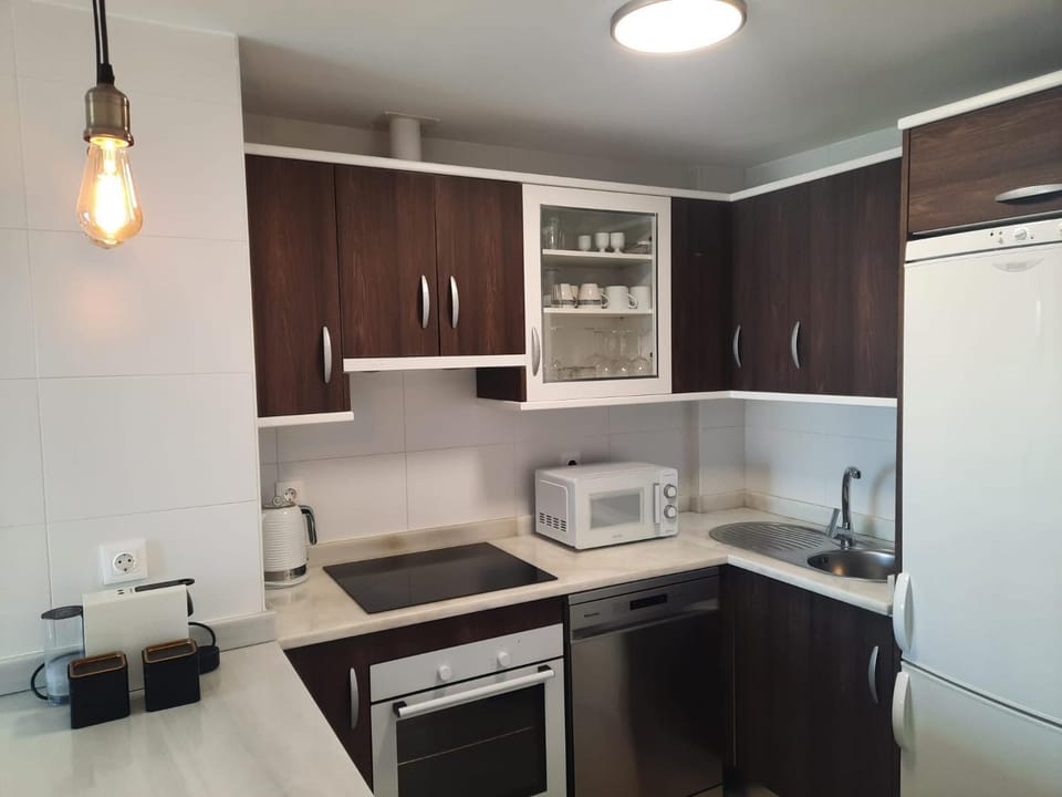 Kitchen or kitchenette, dishwasher, microwave, oven, stove, toaster