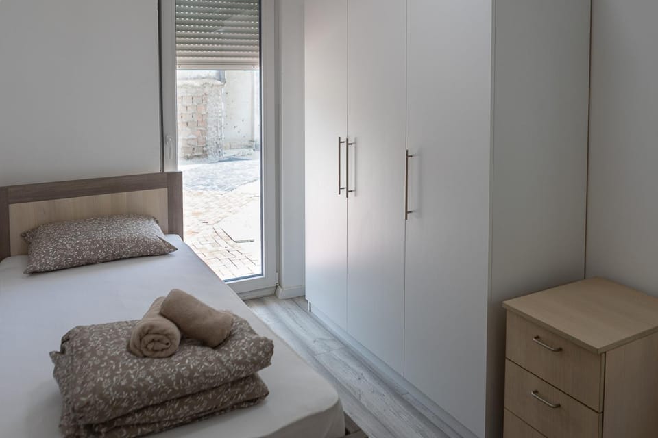 Bed, towels, wardrobe