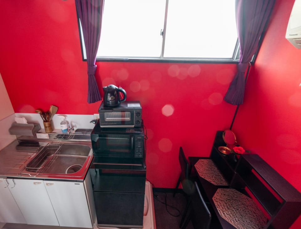 Kitchen or kitchenette, microwave, stove, toaster