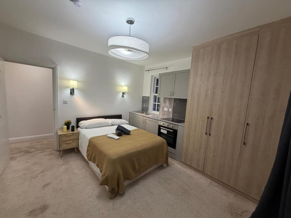 Bed, Kitchen or kitchenette, Bedroom, oven, stove, towels, wardrobe
