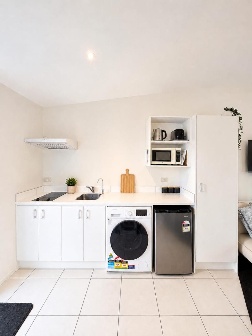 Kitchen or kitchenette, stove, toaster, washing machine