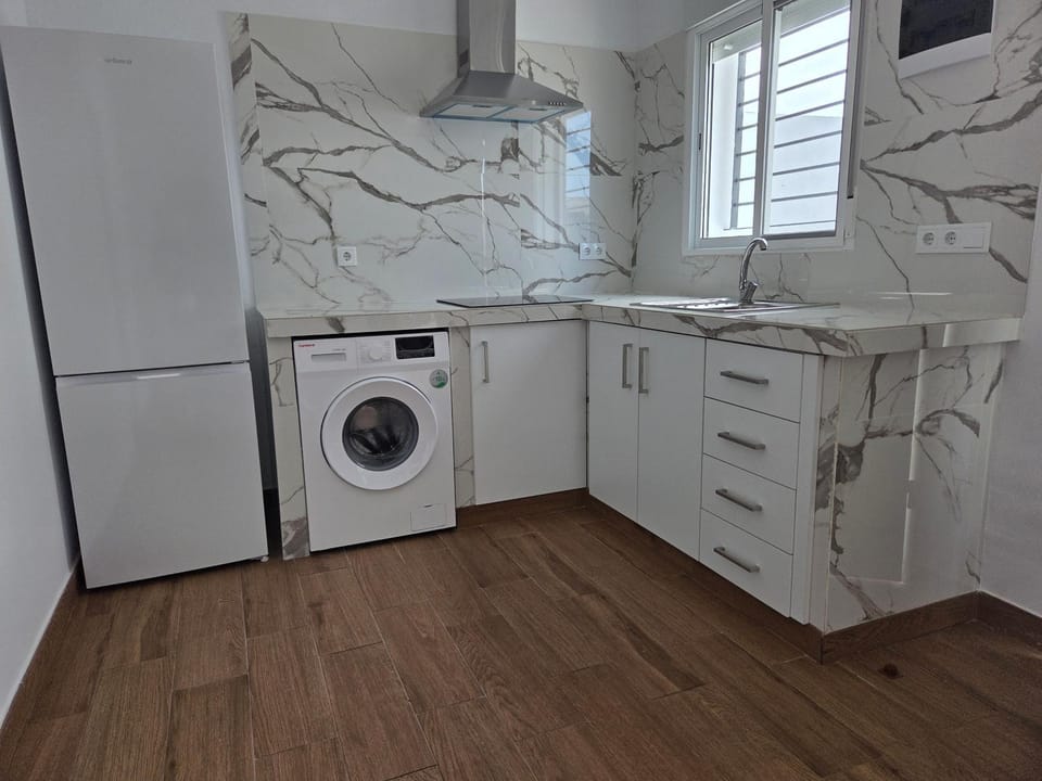 Kitchen or kitchenette, stove, washing machine