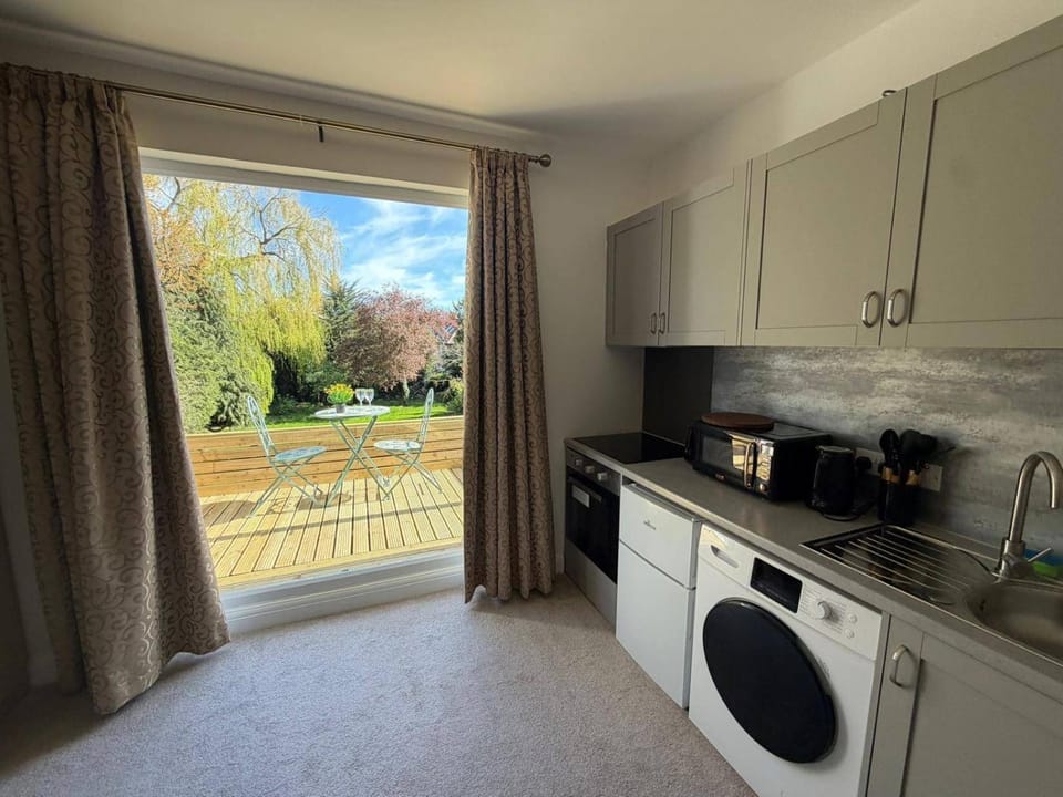Kitchen or kitchenette, microwave, oven, stove, washing machine