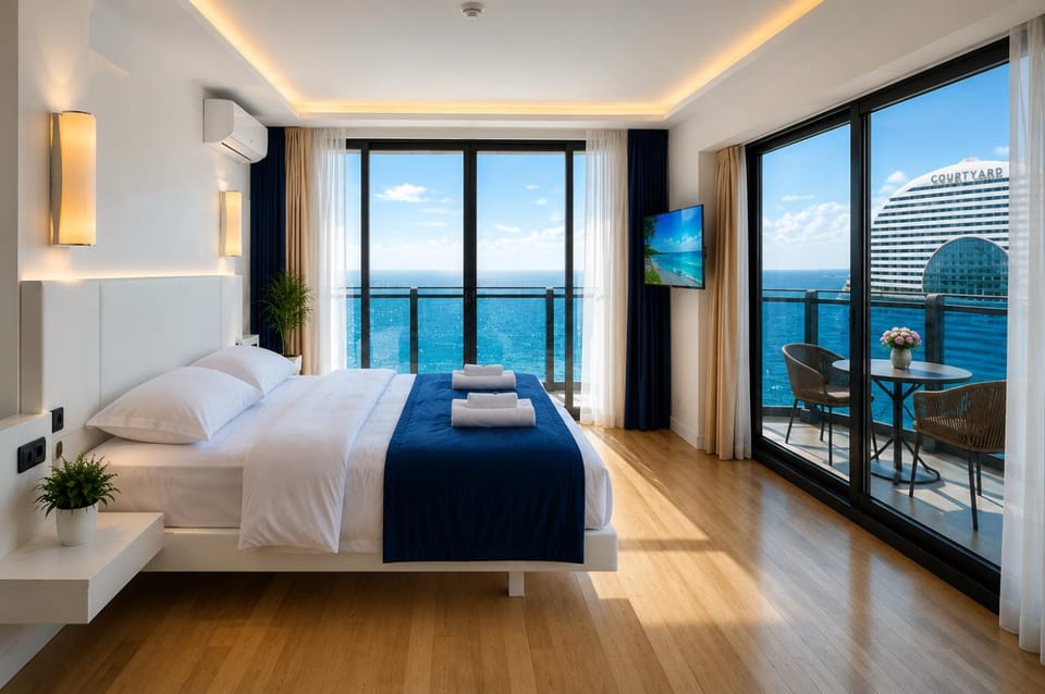 Communal lounge/ TV room, Bed, Natural landscape, TV and multimedia, Living room, Photo of the whole room, Seating area, Evening entertainment, Bedroom, Sea view, towels