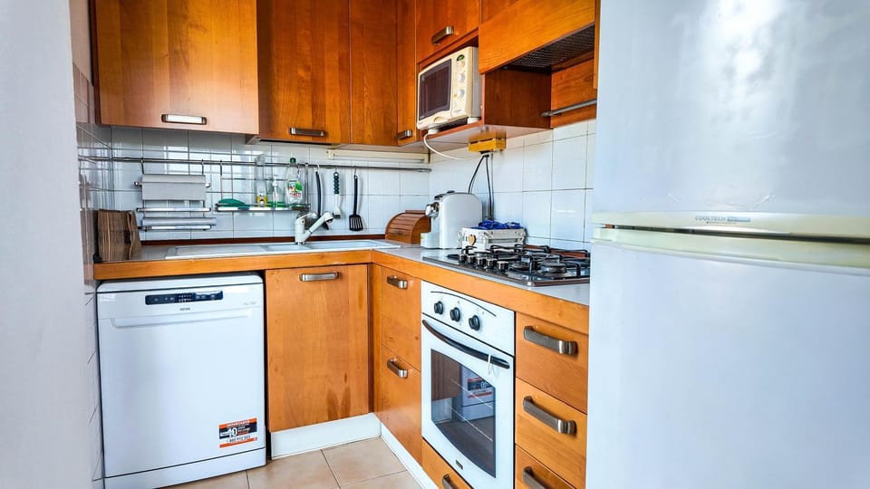Kitchen or kitchenette, dishwasher, microwave, oven, stove